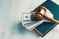 Judge gavel with dollars and law books Royalty Free Stock Photo