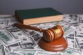 Judge gavel with dollars and law books Royalty Free Stock Photo