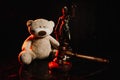 Judge gavel, figure of lady of justice and teddy bear in a court room. Law protection and children concept Royalty Free Stock Photo