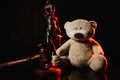 Judge gavel, figure of lady of justice and teddy bear in a dark court room. Law and children concept Royalty Free Stock Photo