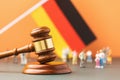 Judge gavel, flag and plastic toy men, the concept of litigation in the German society