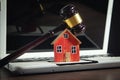 Judge gavel and house model on the computer keyboard Royalty Free Stock Photo