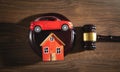 Judge gavel with a house model and toy car on the wooden table Royalty Free Stock Photo