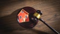 Judge gavel and house model on the wooden table Royalty Free Stock Photo