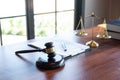 Judge gavel with Justice at law firm in background with legal case document contract, law and justice, attorney, lawsuit