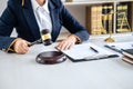 Judge gavel with Justice lawyers, Business woman in suit or lawyer working on a documents in courtroom. Legal law, advice and Royalty Free Stock Photo