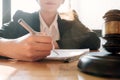 Judge gavel with Justice lawyers, Business woman in suit or lawyer working on a documents. Legal law, advice and justice concept Royalty Free Stock Photo