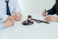 Judge gavel with Justice lawyers deciding, consultation on marriage divorce between married couple and signing divorce documents