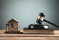 Judge gavel with Law books and house on a wooden table. Law and Justice concept Royalty Free Stock Photo