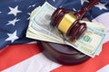 Judge gavel and money on United States of America flag. Many hundred dollar bills under judge malice on USA flag. Judgement and Royalty Free Stock Photo