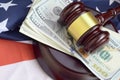 Judge gavel and money on United States of America flag. Many hundred dollar bills under judge malice on USA flag. Judgement and Royalty Free Stock Photo