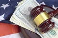 Judge gavel and money on United States of America flag. Many hundred dollar bills under judge malice on USA flag. Judgement and Royalty Free Stock Photo