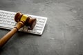 Judge gavel near keyboard - desk of contemporary lawyer - on grey background copy space Royalty Free Stock Photo