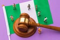 Judge gavel, Nigeria flag and plastic toy men, Nigerian society litigation concept Royalty Free Stock Photo