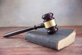 Judge gavel on an old book on a rustic wooden table, concept for Royalty Free Stock Photo