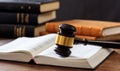 Judge gavel on an open book, wooden desk, law books background Royalty Free Stock Photo