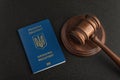 Judge gavel and passport of a citizen of Ukraine. Black background. Obtain citizenship Royalty Free Stock Photo