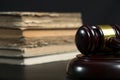 Judge gavel beside pile of books on wooden background Royalty Free Stock Photo