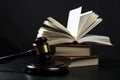 Judge gavel beside pile of books on wooden background Royalty Free Stock Photo