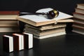 Judge gavel beside pile of books on wooden background Royalty Free Stock Photo