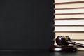 Judge gavel beside pile of books on wooden background Royalty Free Stock Photo