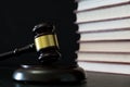 Judge gavel beside pile of books on wooden background Royalty Free Stock Photo