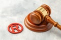 Judge gavel and red trademark sign on gray