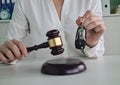 Judge gavel and remote control from car are on table in judge hand