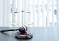 Judge gavel, scales of justice on the office desk, the white background office of a lawyer or judge Royalty Free Stock Photo