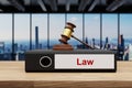 Judge gavel standing on black office binder file folder on wooden desk in large modern office building; witness label; skyline Royalty Free Stock Photo