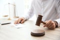 Judge with gavel at table in courtroom. Law and justice concept Royalty Free Stock Photo