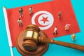 Judge gavel, Tunisian flag and plastic toy men on blue background, Tunisian society litigation concept Royalty Free Stock Photo