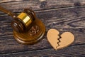 Judge gavel and wedding rings, with a broken heart. Divorce proceedings, marriage contract, alimony Royalty Free Stock Photo