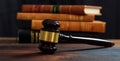 Judge gavel on a wooden desk, law books background Royalty Free Stock Photo