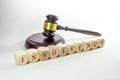 Judge gavel and wooden dices with the word Insolvency, some companies have to close after the coronavirus crisis, gray background Royalty Free Stock Photo