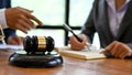 A judge gavel is on the wooden office desk over blurred background a lawyer meeting Royalty Free Stock Photo