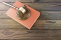 Judge hammer, book on a wooden background. Royalty Free Stock Photo