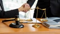 The judge hammer and the scales of a fair uncle on a table where a lawyer advises clients. Royalty Free Stock Photo