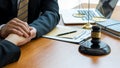 The judge hammer and the scales of a fair uncle on a table where a lawyer advises clients. Royalty Free Stock Photo