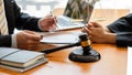 The judge hammer and the scales of a fair uncle on a table where a lawyer advises clients. Royalty Free Stock Photo