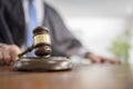 Judge holding gavel in court room giving verdict background Royalty Free Stock Photo