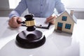 Judge With House Model Hitting Gavel Royalty Free Stock Photo