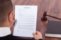 Judge reading contract in courtroom Royalty Free Stock Photo