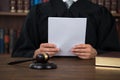 Judge Reading Document At Desk In Courtroom Royalty Free Stock Photo