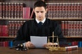 Judge Reading Documents At Desk In Courtroom Royalty Free Stock Photo