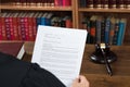 Judge Reading Legal Documents At Desk In Courtroom Royalty Free Stock Photo