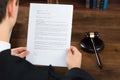 Judge Reading Legal Documents At Desk In Courtroom Royalty Free Stock Photo