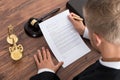 Judge Reading Paper In Courtroom