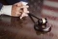 Judge Rests Hands Behind Gavel with American Flag Table Reflection Royalty Free Stock Photo