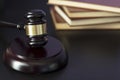 Judge`s gavel on black table with law books on the background. Law and justice concept Royalty Free Stock Photo